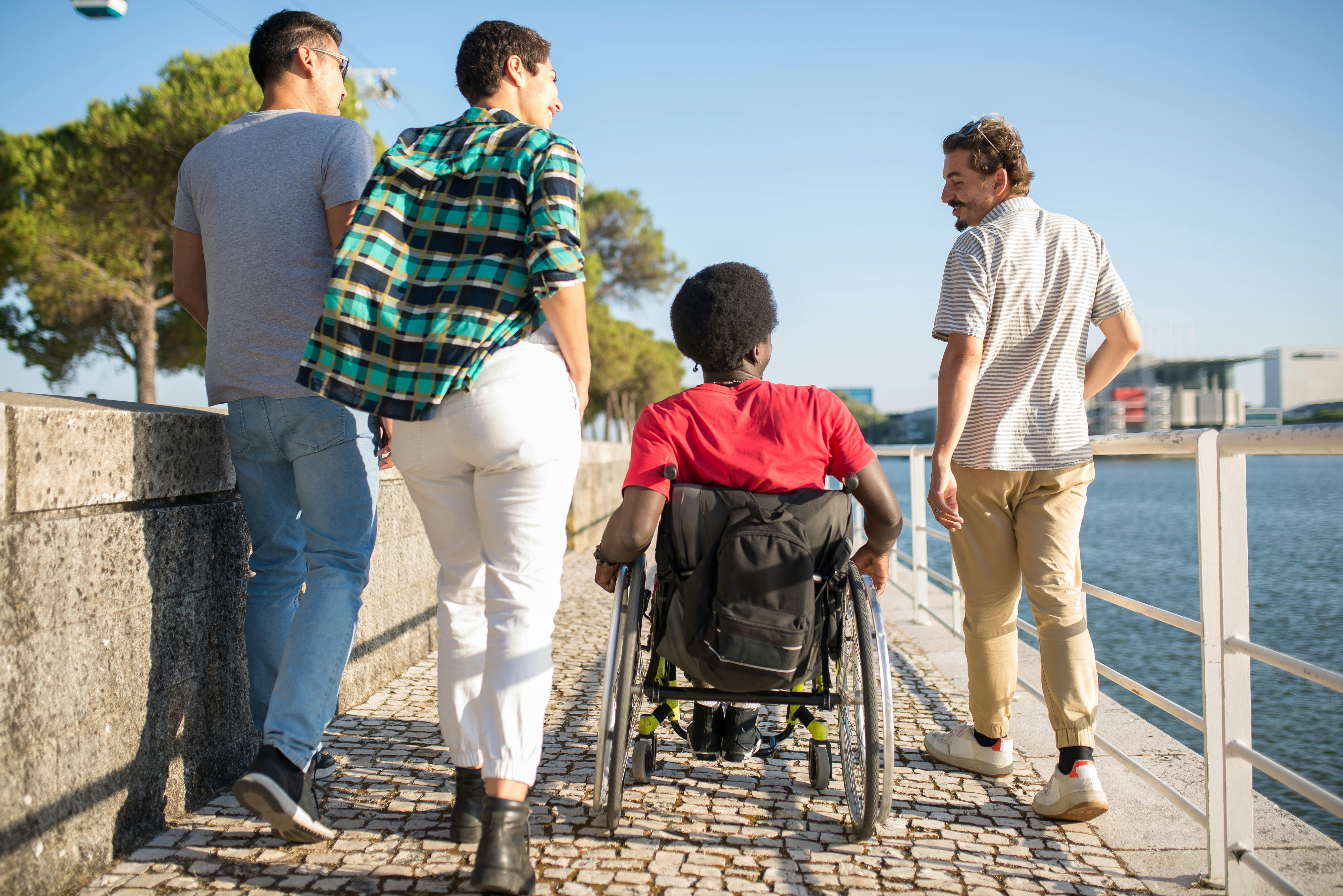 Group including wheelchair user enjoying community outdoors